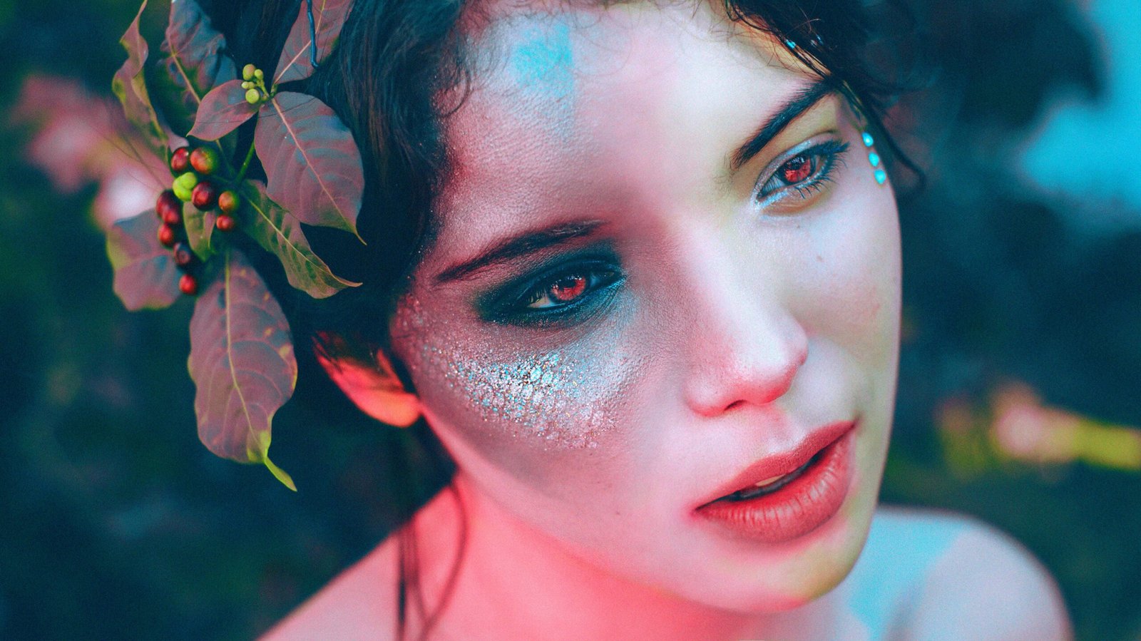 Artistic portrait of a woman with unique makeup and leaf headdress, evoking fantasy and elegance.